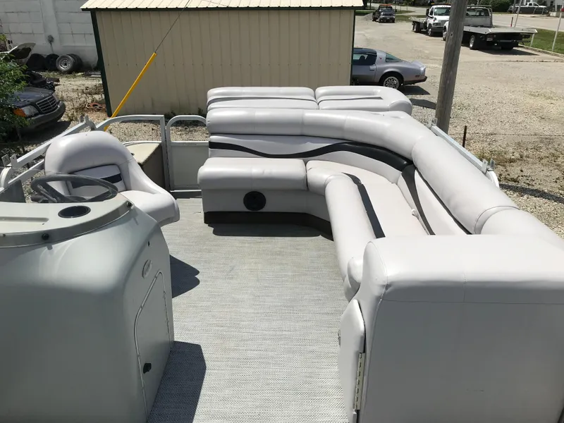 Slide: The Image of 1998 Bennington 2050LX pontoon boat interior with spacious seating and steering console. - 8