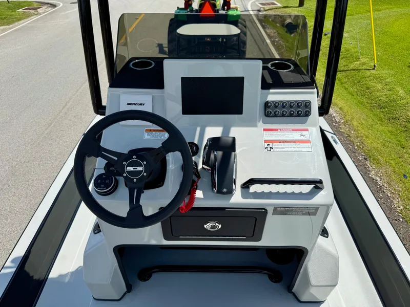 Slide: The Image of 2025 SCB R24 boat console with steering wheel, controls, and Mercury branding. - 10