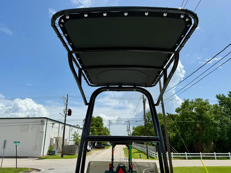 Slide: The Image of 2025 SCB R24 boat T-top against a clear blue sky. - 11