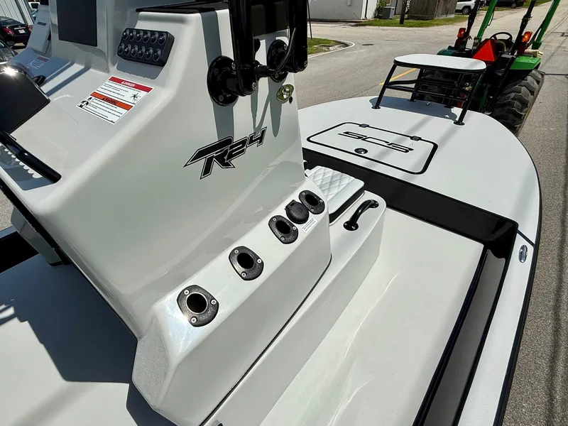 Slide: The Image of 2025 SCB R24 boat console with rod holders and sleek design. - 14