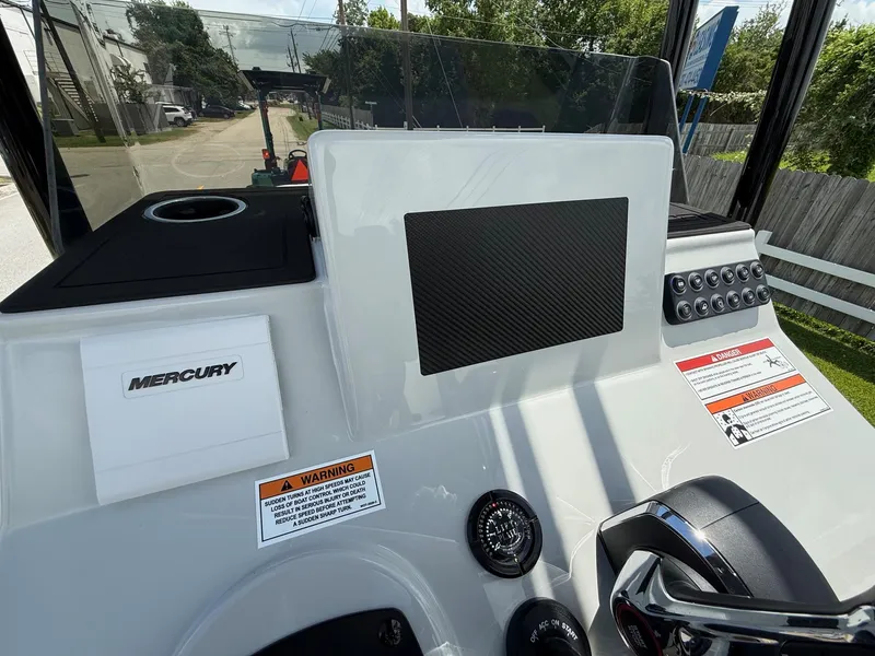 Slide: The Image of 2025 SCB R24 boat dashboard with Mercury controls and warning labels. - 16