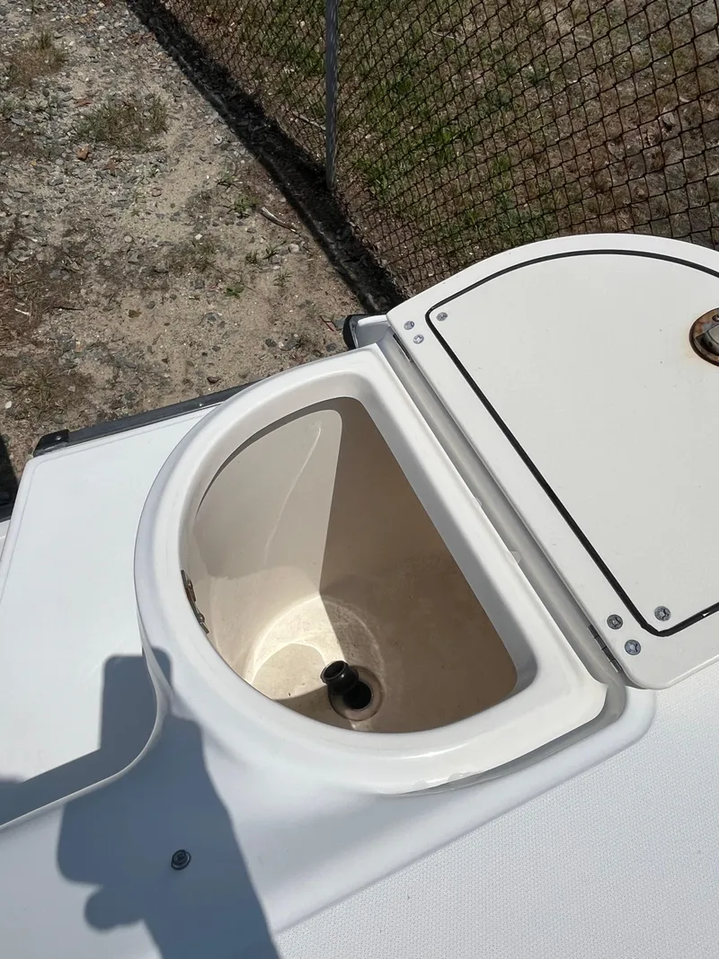 Slide: The Image of Open storage compartment on a 2005 Boston Whaler 210 Ventura boat. - 12