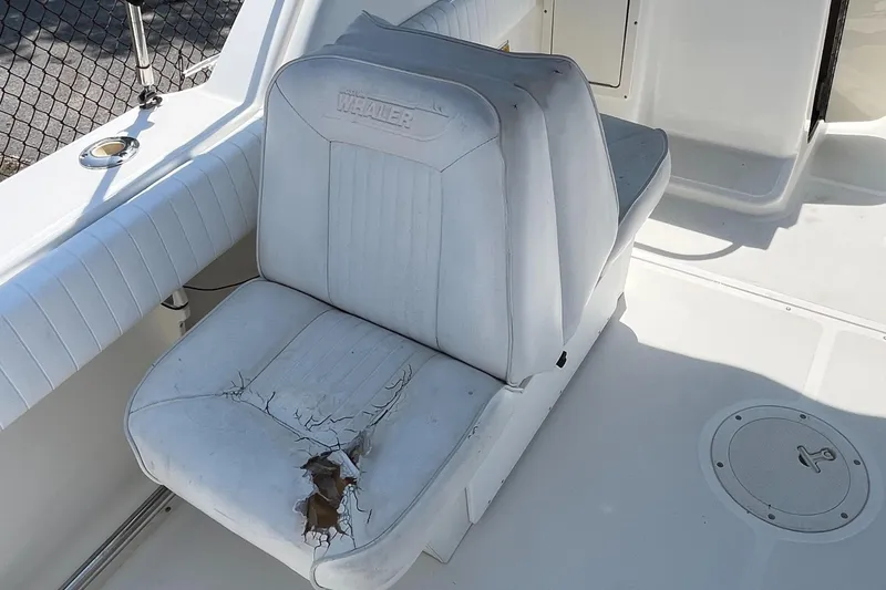 Slide: The Image of Worn seat on 2005 Boston Whaler 210 Ventura boat, showing visible damage and wear. - 18