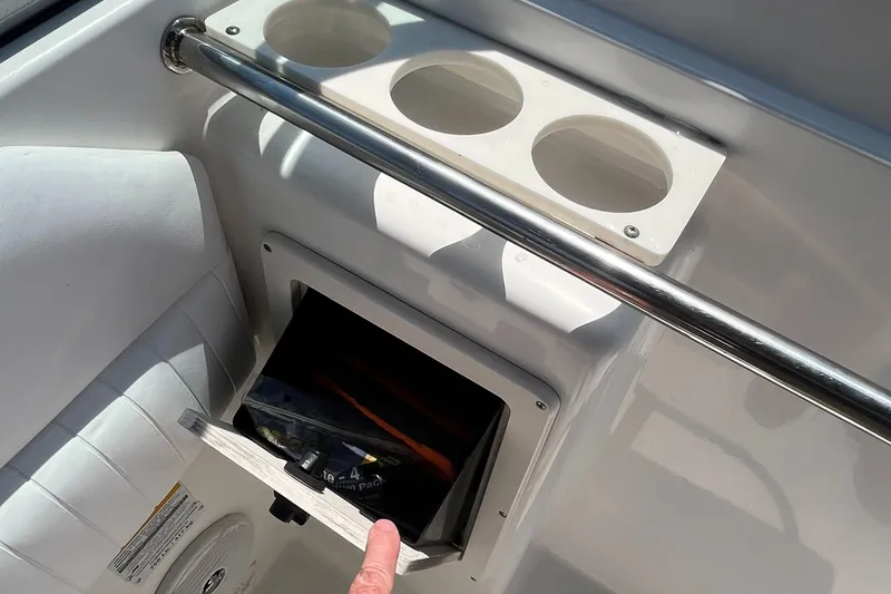 Slide: The Image of 2005 Boston Whaler 210 Ventura boat interior with cup holders and storage compartment. - 20