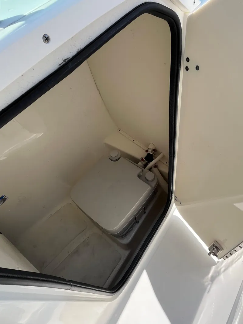 Slide: The Image of 2005 Boston Whaler 210 Ventura boat interior with compact toilet compartment. - 21
