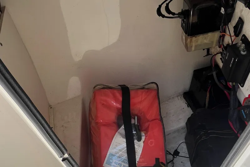 Slide: The Image of Storage compartment of a 2005 Boston Whaler 210 Ventura boat with equipment and wiring. - 22