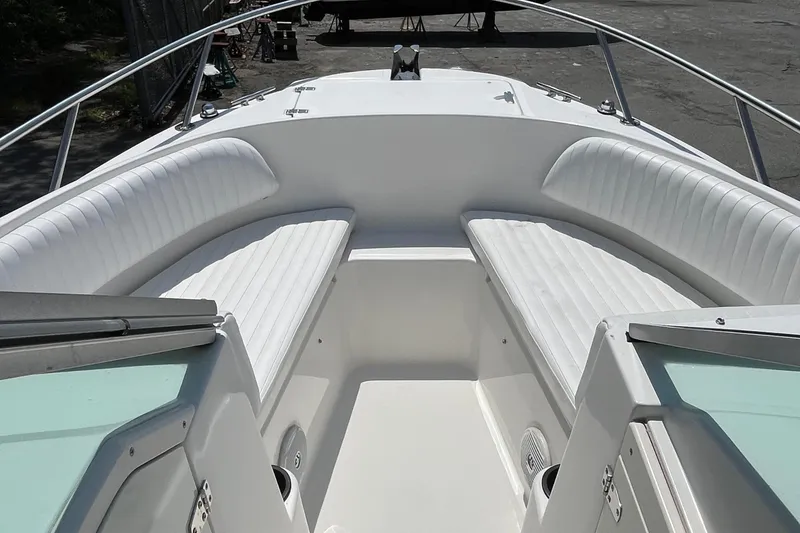 Slide: The Image of 2005 Boston Whaler 210 Ventura boat interior with white cushioned seating. - 23