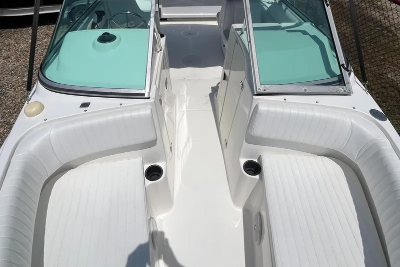 Slide: The Image of 2005 Boston Whaler 210 Ventura boat interior with white seating and windshield. - 25
