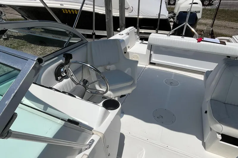 Slide: The Image of 2005 Boston Whaler 210 Ventura boat interior with steering wheel and seating. - 27
