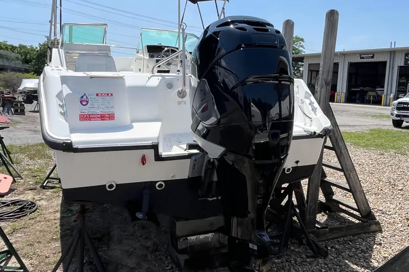 Slide: The Image of 2005 Boston Whaler 210 Ventura boat with outboard motor, displayed outdoors for sale. - 31