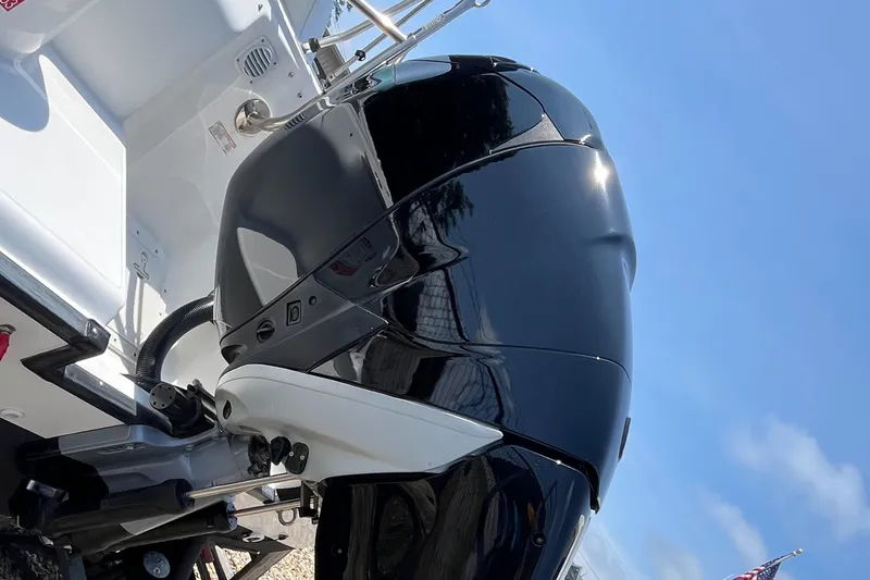 Slide: The Image of 2005 Boston Whaler 210 Ventura boat engine, close-up view under clear blue sky. - 4