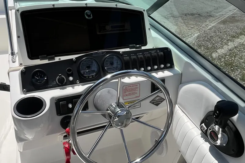 Slide: The Image of 2005 Boston Whaler 210 Ventura boat dashboard with steering wheel and control panel. - 7