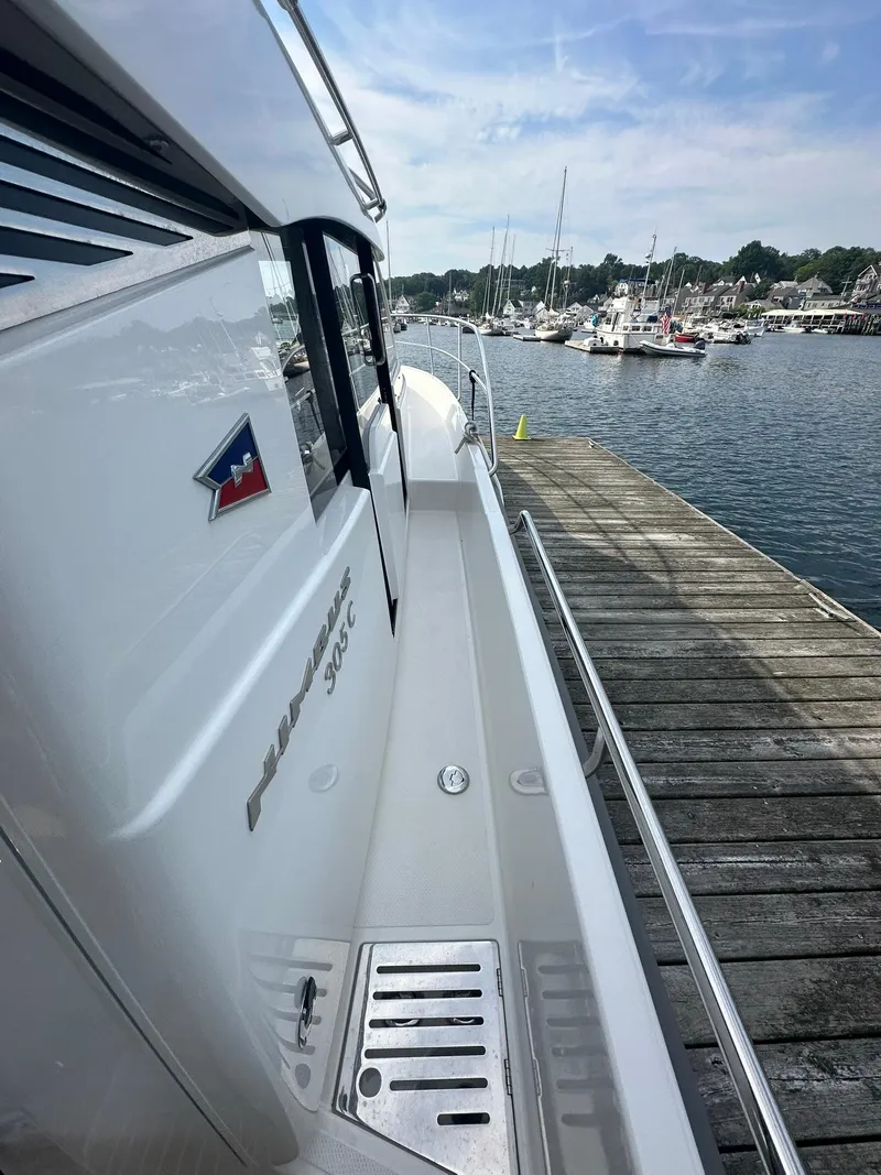 Slide: The Image of 2024 Nimbus 305 Coupe docked at a marina, showcasing sleek design and craftsmanship. - 18