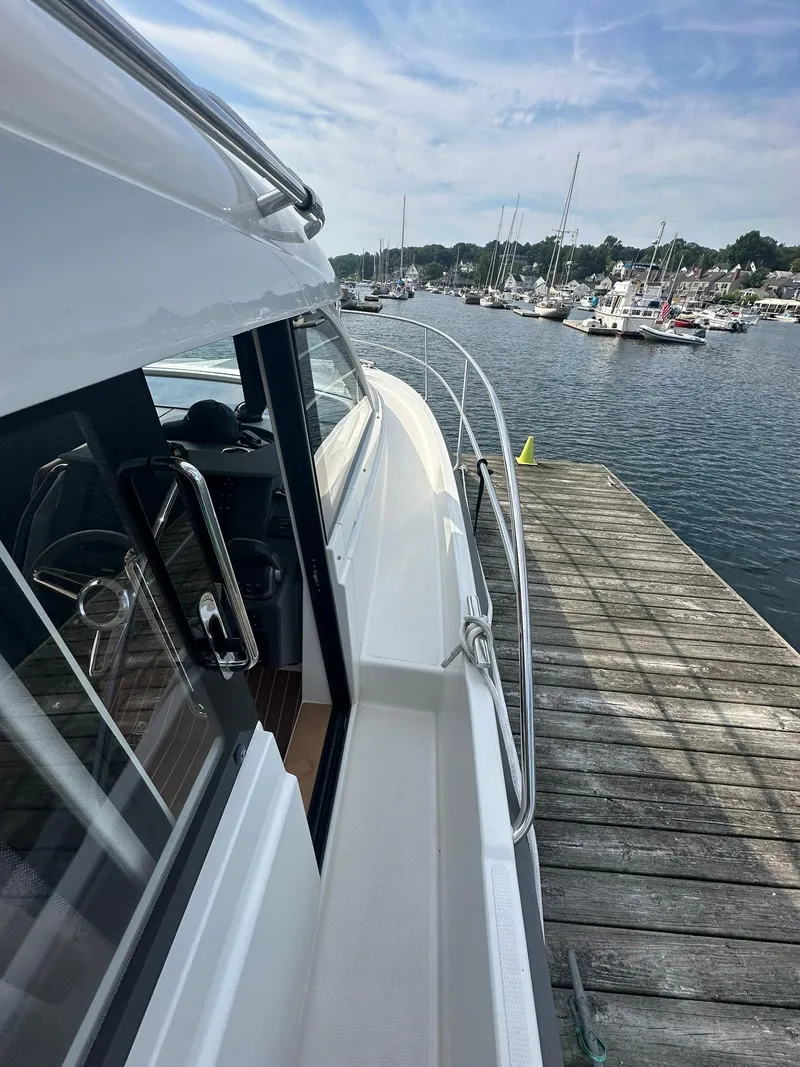Slide: The Image of Nimbus 305 Coupe 2024 docked at a marina, showcasing sleek design and waterfront view. - 22