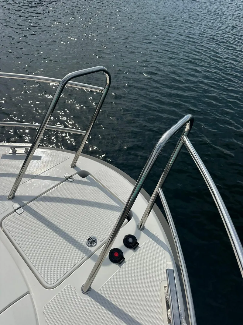 Slide: The Image of Bow of 2024 Nimbus 305 Coupe with stainless steel railings on calm water. - 37