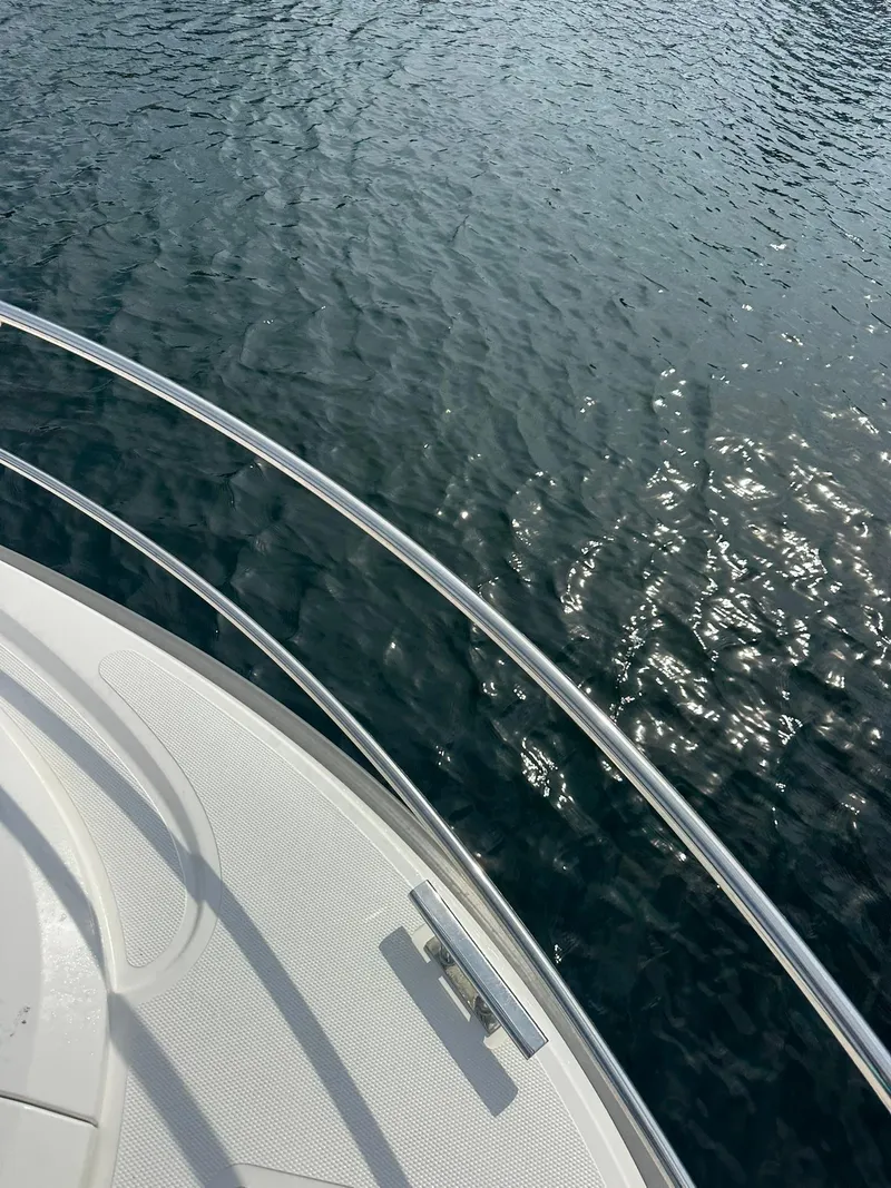 Slide: The Image of Bow of 2024 Nimbus 305 Coupe on water, showcasing sleek design and railing. - 42