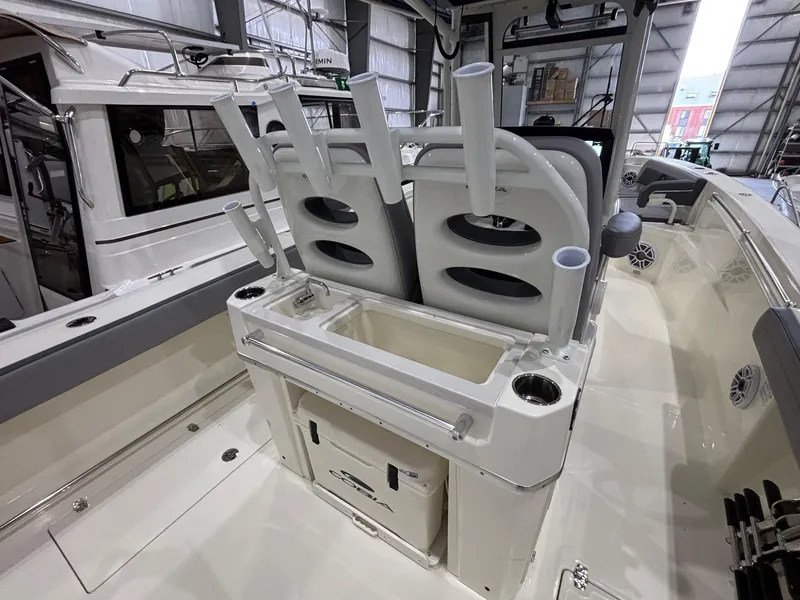 Slide: The Image of 2025 Cobia 285 Center Console boat interior with rod holders and storage compartments. - 13