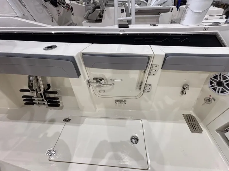 Slide: The Image of 2025 Cobia 285 Center Console boat interior with storage compartments and seating. - 19