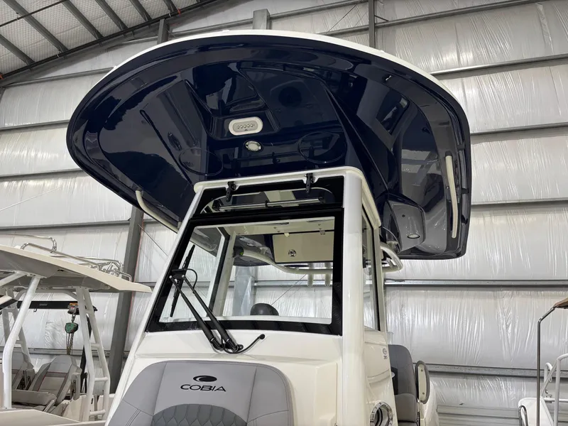 Slide: The Image of 2025 Cobia 285 Center Console boat in a storage facility, showcasing its sleek design. - 4