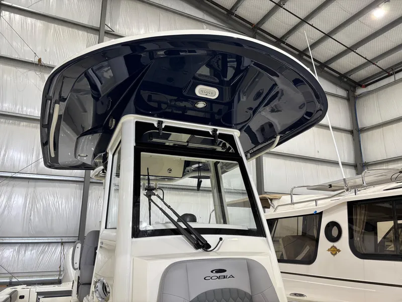 Slide: The Image of 2025 Cobia 285 Center Console boat in a warehouse, showcasing its sleek design. - 5