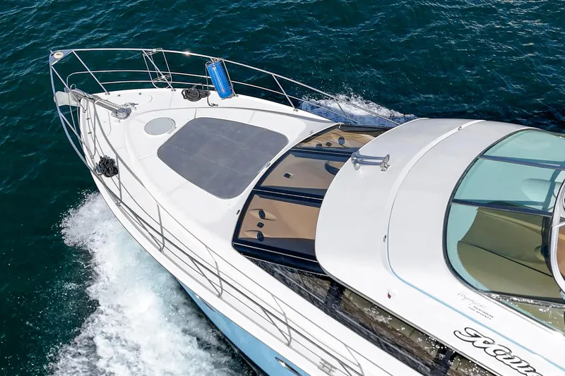 Slide: The Image of 2003 Carver 570 Voyager Pilothouse cruising on open water, aerial view. - 10