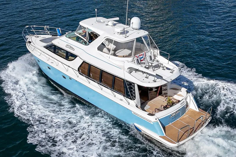 Slide: The Image of 2003 Carver 570 Voyager Pilothouse yacht cruising on open water. - 2