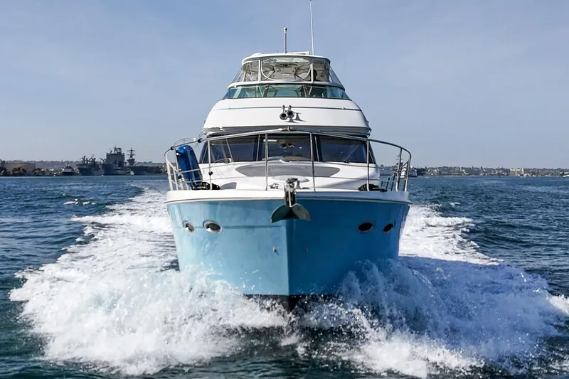 Slide: The Image of 2003 Carver 570 Voyager Pilothouse cruising on open water, front view. - 21