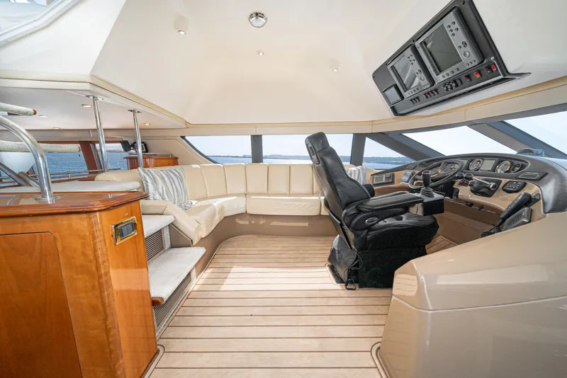 Slide: The Image of Luxurious 2003 Carver 570 Voyager Pilothouse interior with leather seating and modern controls. - 28