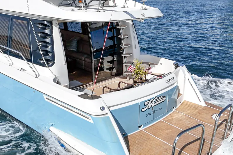 Slide: The Image of 2003 Carver 570 Voyager Pilothouse yacht cruising on open water. - 29