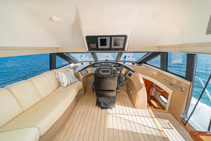 Slide: The Image of Interior of 2003 Carver 570 Voyager Pilothouse with luxurious seating and navigation controls. - 39