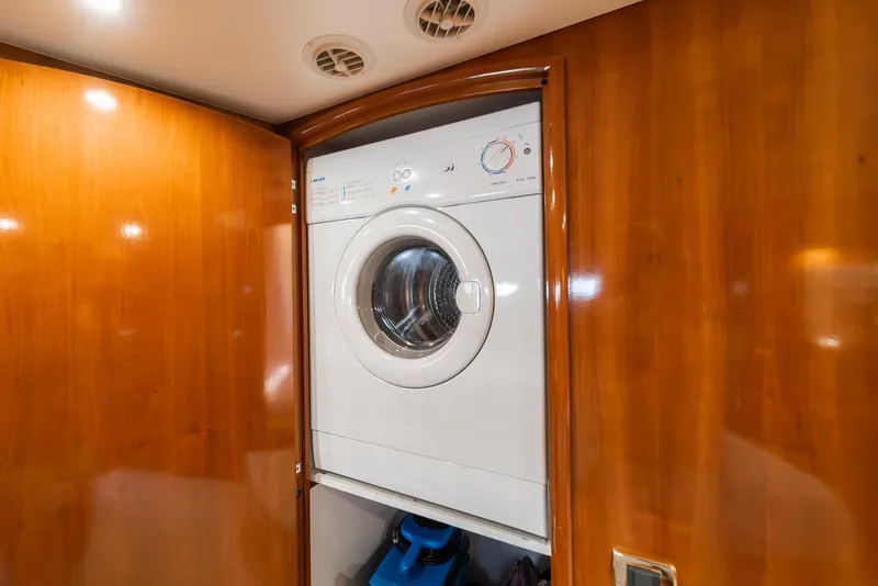 Slide: The Image of Washing machine inside 2003 Carver 570 Voyager Pilothouse yacht with wooden interior. - 42