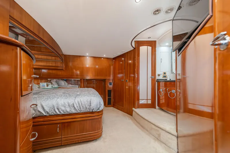 Slide: The Image of Luxurious 2003 Carver 570 Voyager Pilothouse bedroom with elegant wood finishes and modern amenities. - 44