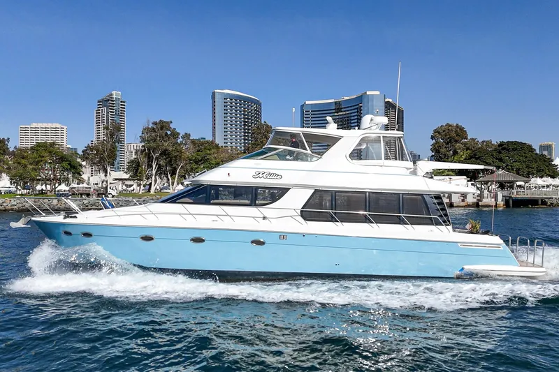 Slide: The Image of 2003 Carver 570 Voyager Pilothouse yacht cruising near city skyline. - 6