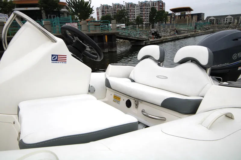 Slide: The Image of 2022 Zodiac Yachtline 360DL NEO boat interior with white seating and steering wheel. - 4