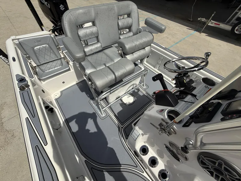 Slide: The Image of 2022 Blue Wave 2400 PureBay boat console with steering wheel and navigation equipment. - 12