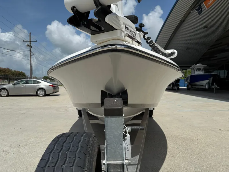 Slide: The Image of 2022 Blue Wave 2400 PureBay boat on trailer, parked outdoors under cloudy sky. - 3