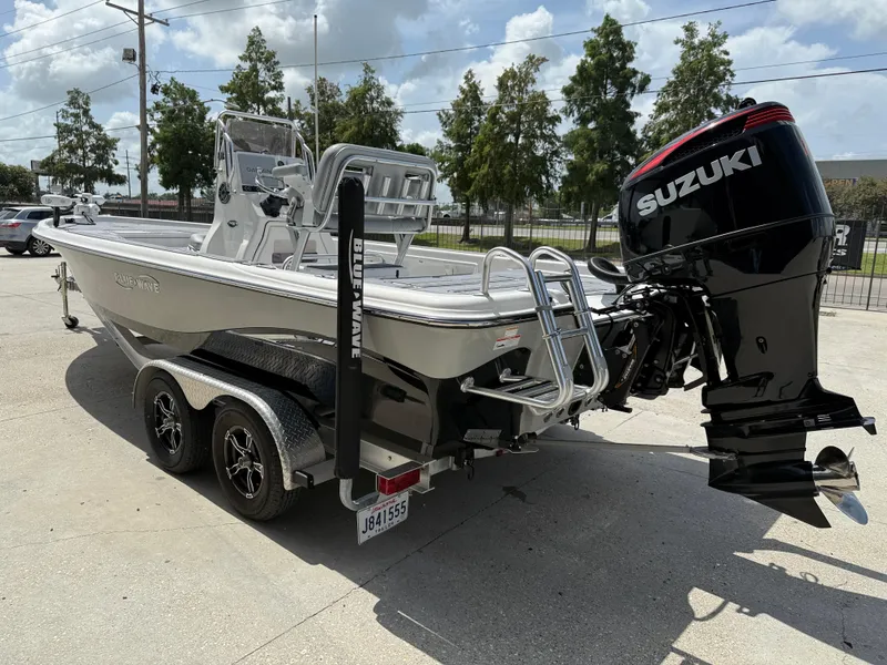 Slide: The Image of 2022 Blue Wave 2400 PureBay boat rear view with powerful outboard motor. - 5