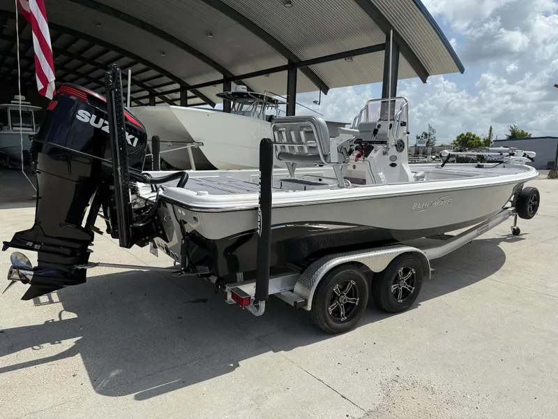 Slide: The Image of 2022 Blue Wave 2400 PureBay boat interior with Yeti cooler and Garmin equipment. - 7