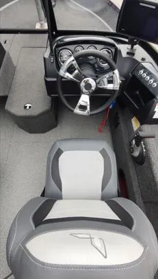 Slide: The Image of 2023 Lowe FM 1775 boat interior with steering wheel and dashboard controls. - 13