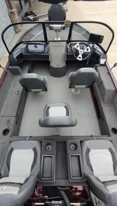 Slide: The Image of 2023 Lowe FM 1775 boat interior with seating and steering console. - 17