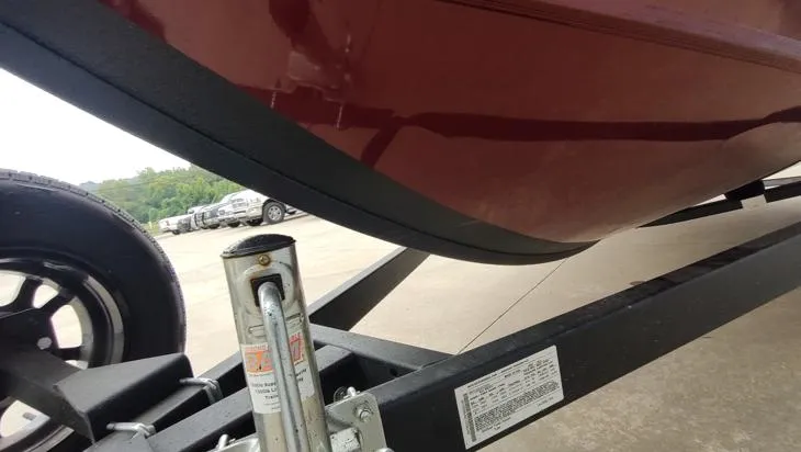 Slide: The Image of 2023 Lowe FM 1775 boat on trailer, close-up view of hull and wheel. - 5