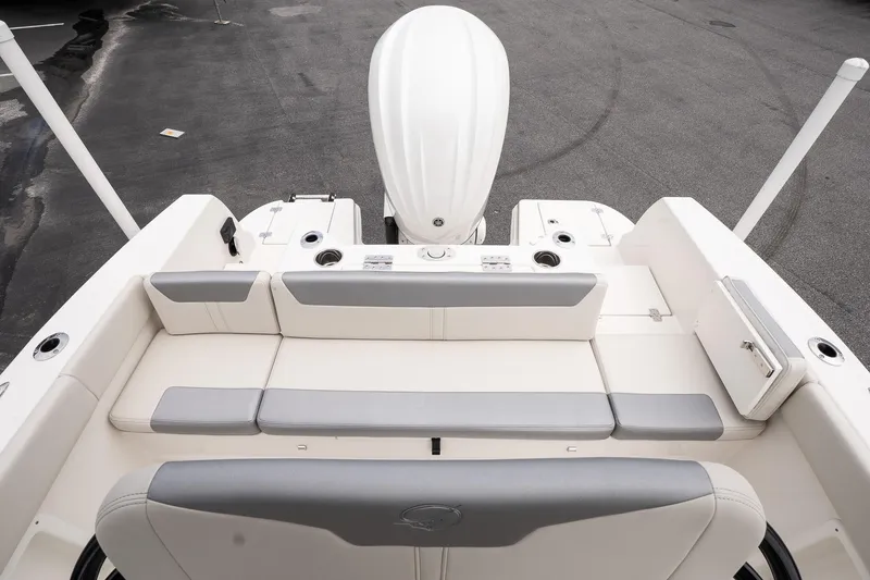 Slide: The Image of 2026 Sailfish 232 CC boat interior with cushioned seating and outboard motor. - 10