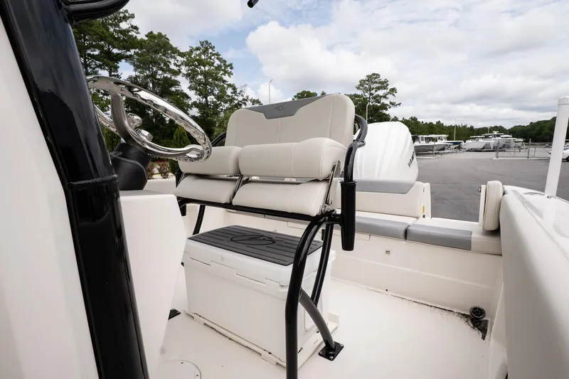 Slide: The Image of 2026 Sailfish 232 CC boat interior with steering wheel and seating. - 11