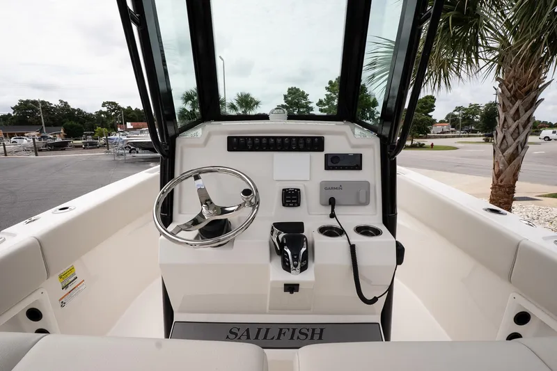 Slide: The Image of 2026 Sailfish 232 CC boat console with steering wheel and navigation controls. - 12