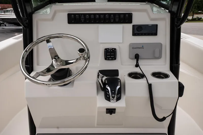 Slide: The Image of 2026 Sailfish 232 CC boat console with steering wheel, Garmin system, and control panel. - 14