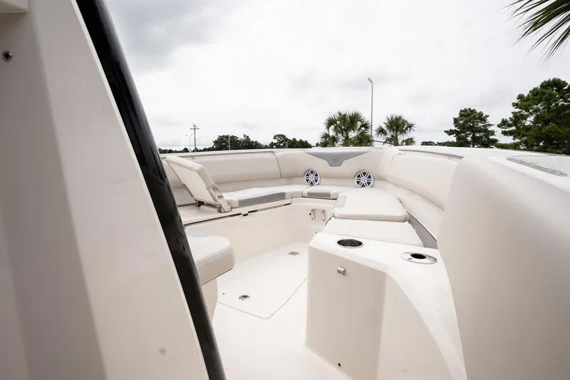 Slide: The Image of 2026 Sailfish 232 CC boat interior with cushioned seating and cup holders. - 15