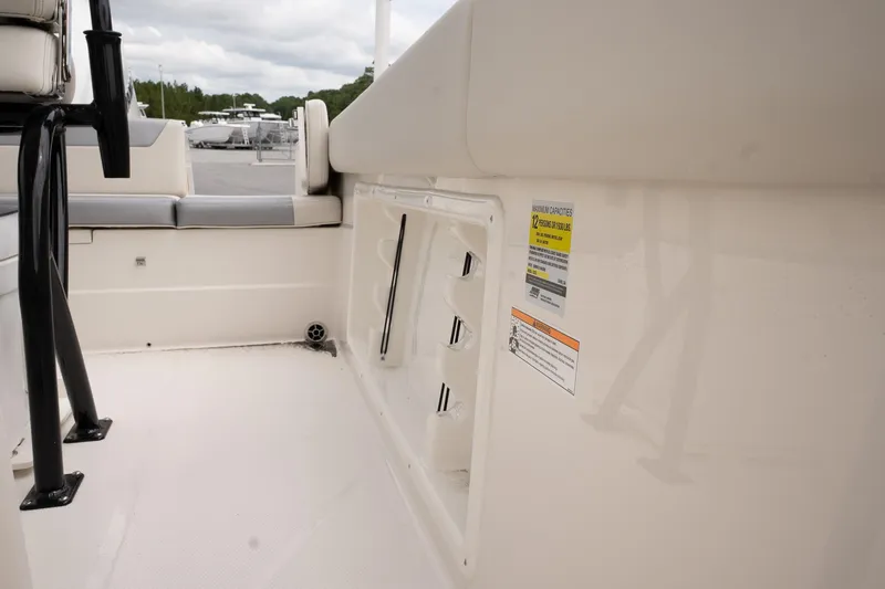 Slide: The Image of Interior view of 2026 Sailfish 232 CC boat, featuring seating and safety labels. - 21