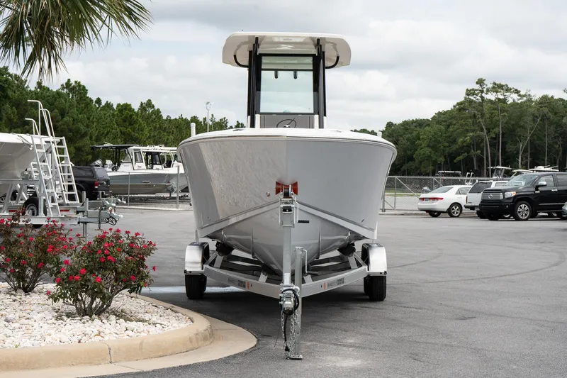 Slide: The Image of 2026 Sailfish 232 CC boat on trailer in parking lot, surrounded by trees and cars. - 3