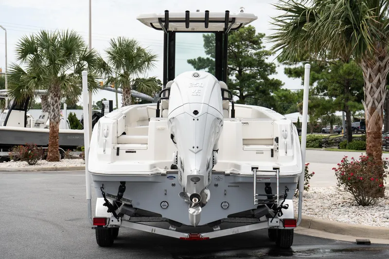 Slide: The Image of 2026 Sailfish 232 CC boat on trailer, surrounded by palm trees and landscaping. - 5