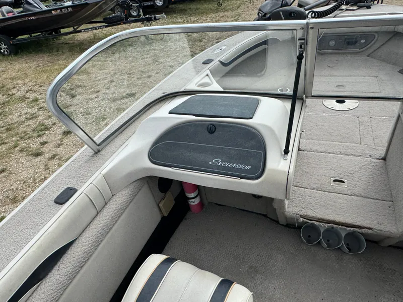 Slide: The Image of Interior of a 2000 Sylvan 1900 Excursion boat with seating and dashboard. - 11